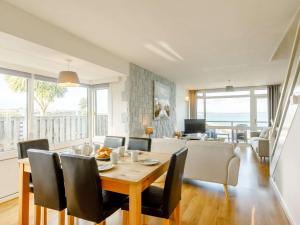 a dining room and living room with a table and chairs at 3 bed property in Brixham BX034 in Brixham