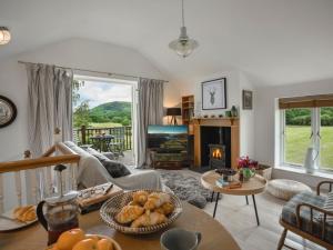 a living room with a couch and a fireplace at 1 Bed in Coniston LCC37 in High Nibthwaite