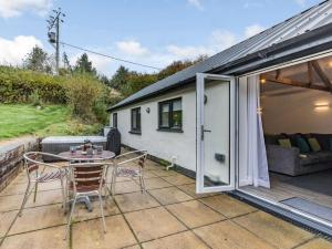 a patio with a table and chairs and a caravan at 2 Bed in Woolacombe 60443 in Bittadon