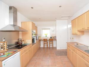 a kitchen with wooden cabinets and a counter top at 2 Bed in Carnoustie 58026 in Monikie