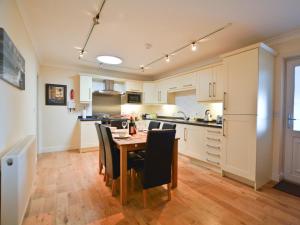 a kitchen with a table and chairs in a room at 2 Bed in Seahouses CN198 in Seahouses