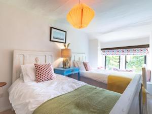 a bedroom with two beds and a blue table at 4 bed in Priestcliffe 57687 in Millers Dale