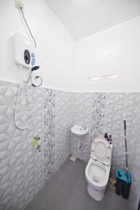 a bathroom with a toilet and a shower at OYO 90908 Noor Arfa River Chalet in Kuala Terengganu