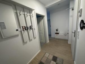 a hallway with a door with a home sign on it at Ferienwohnung SEESTERN **** in Rostock