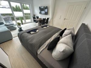 a bedroom with a large bed and a couch at Ferienwohnung SEESTERN **** in Rostock
