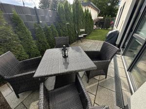 a table and chairs sitting on a patio at Ferienwohnung SEESTERN **** in Rostock +12 photos