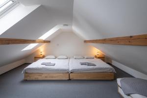 a bedroom with a bed in a attic at Apartmány pro rodiny s dětmi - Permoník in Dolní Malá Úpa