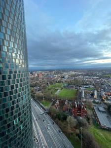 a view of a city from a tall building at cozy 2 Bed Flat free parking, Manchester City Centre in Manchester