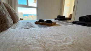 a bed with two cups sitting on top of it at Carabela-C704 in Torrox Costa