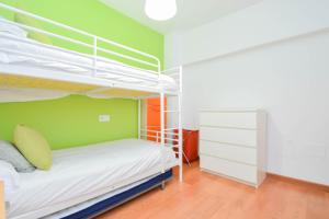 a bedroom with two bunk beds and a green wall at Violeta in Granada