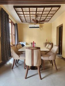 a dining room with a table and chairs at Richak Ganges villa in Kolkata