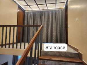 a stairwell with a curtain with the word staircase at Richak Ganges villa in Kolkata