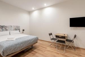 a bedroom with a bed and a desk and a tv at 1 bedroom 1 bathroom furnished - Justicia - Modern - MintyStay in Madrid
