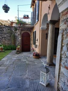 an entrance to a building with a door and a lantern at Casa Longhi in Orta San Giulio