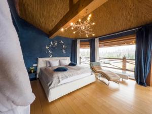 a bedroom with a white bed and a chandelier at Jonathan Spa Estate in Amatciems
