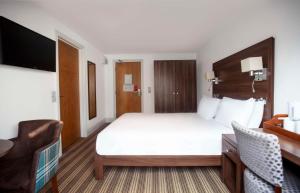 a hotel room with a large bed and a desk at Best Western Brome Grange Hotel in Brome +82 photos