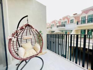 a hanging rattan chair on a balcony at German Quality Luxury Studio in Dubai
