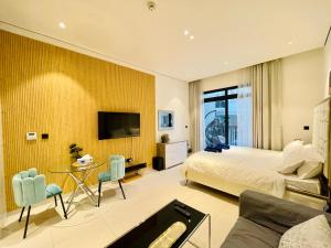 a hotel room with a bed and a tv at German Quality Luxury Studio in Dubai