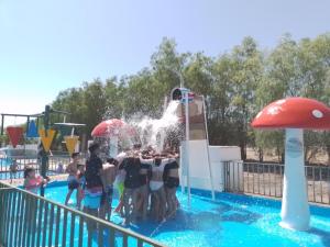 a group of children playing in a water park at Cabañas Ecodesert in La Tirana