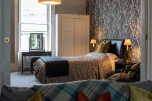 a hotel room with two beds and a piano at Spacious, Light-filled Central Period Apartment in Bath