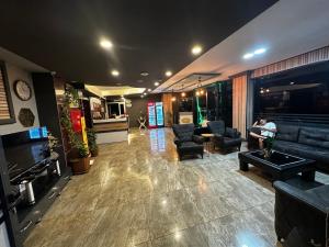 a lobby with couches and a person sitting on a couch at Comfort Başaran OTEL in Antalya