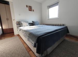 Postel nebo postele na pokoji v ubytování Nikolic Apartment