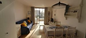 a living room with a blue couch and a table at Santiago 2 Las Americas duplex 2 Dormitorios in Playa de las Americas