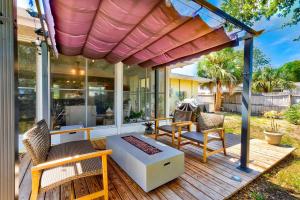 a screened in porch with chairs and a bench at Largo Beach House in Largo