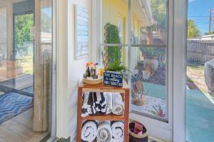 a room with a shelf with shoes and a window at Largo Beach House in Largo