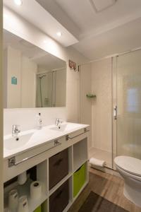 a bathroom with a sink and a shower and a toilet at Alda Centro Zamora in Zamora +36 photos