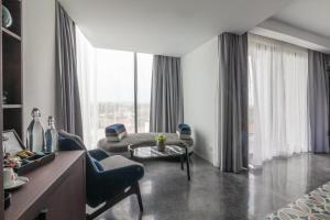 a living room with a couch and a chair at Hotel Vellita Siem reap in Siem Reap