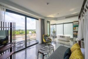 a large bathroom with a tub and a balcony at Hotel Vellita Siem reap in Siem Reap