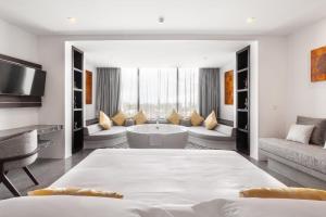 a large living room with a tub and a couch at Hotel Vellita Siem reap in Siem Reap +139 photos