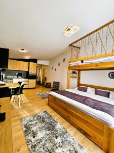 a bedroom with a large bed and a kitchen at H11 - Evergreen Tale in Bystrá