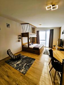 a bedroom with a bed and a table and a room at H11 - Evergreen Tale in Bystrá