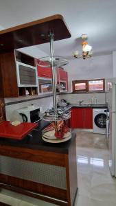 a kitchen with red cabinets and a counter top at Pensiunea Toma in Ploieşti