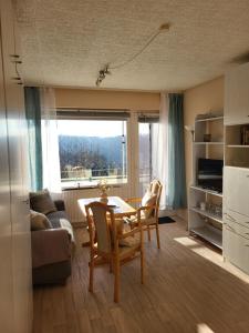 a living room with a table and chairs and a couch at FeWo Talblick 22 in Bad Lauterberg