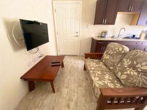 ein Wohnzimmer mit einem Sofa und einem Couchtisch in der Unterkunft SkylineSuites Lost in Paradise - FA3 in Grand Anse