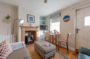 a living room with a couch and a table at Angel Cottage in Southwold
