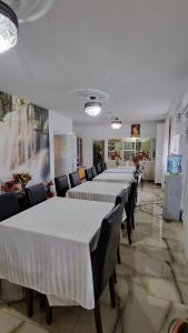 a row of tables and chairs in a room at Pensiunea Toma in Ploieşti