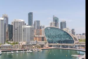 a view of a large city with boats in the water at Spectacular Darling Harbour View Apartment & Parking in Sydney