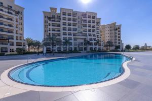 a large swimming pool in front of a building at New Listing - Pool & Beach View - Czechin - RAK in Ras al Khaimah
