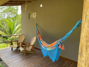 - un hamac sur une terrasse avec 2 chaises dans l'établissement Vila dos Anjos Itacaré, à Itacaré