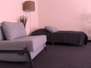 a living room with a couch and a bed at Gästehaus Pacia & Ritter in Sangerhausen