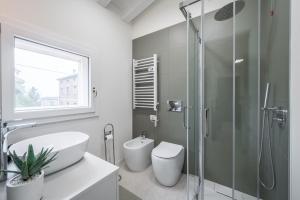 a bathroom with a shower and a sink and a toilet at Loft Design Free Parking - Maranello - Sassuolo in Casalgrande +12 photos