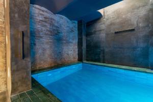 a swimming pool in a room with a brick wall at Tendency Apartments 9 in Barcelona