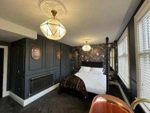 a bedroom with a swing bed and two lights at Eastgate Rows Apartments in Chester