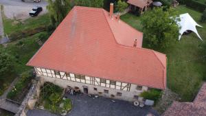 an overhead view of a large house with a red roof at Pension Stadtmühle Allstedt in Allstedt