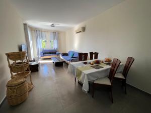 a living room with a table and a couch at Sea-View Eco-Apartment B110 in Polis Chrysochous