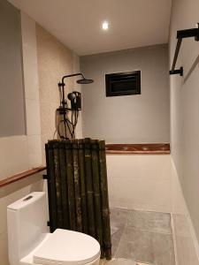 a bathroom with a toilet and a shower at Resting Place Ko Yao Yai in Ko Yao Yai